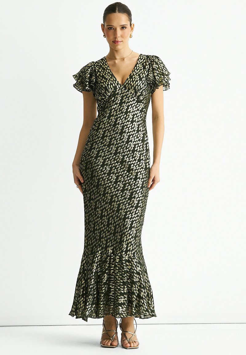Maxi dress in a dark green fabric featuring a gold polka dot pattern, v-neckline, flutter sleeves, and a flared hem detail.