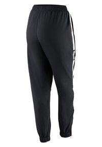 Pantalones deportivos negros con cintura elástica, franjas laterales blancas, un bolsillo con cremallera y puños ajustados. Tejido que absorbe la humedad.