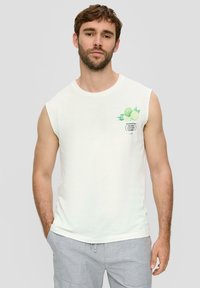 White sleeveless cotton t-shirt featuring a green lime graphic and text on the left side. Smooth texture, casual fit, round neckline.