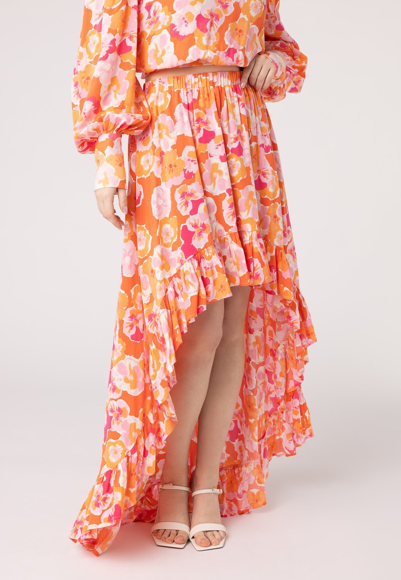 Floral maxi rok in oranje, roze en gele tinten met een gerimpelde zoom. Gemaakt van lichtgewicht stof, met een elastische taille voor comfort.