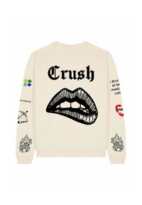 Krém színű pulóver, amelyen egy nagy fekete száj grafika látható a "Crush" szóval, valamint különböző színes és fekete minták a ujjain.