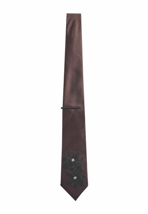 Brown satin tie featuring black floral design with white accents, slim shape, and a flat tie clip for secure fastening.