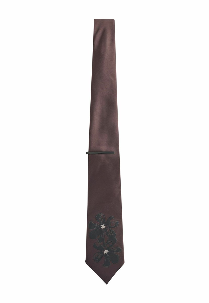 Brown satin tie featuring black floral design with white accents, slim shape, and a flat tie clip for secure fastening.
