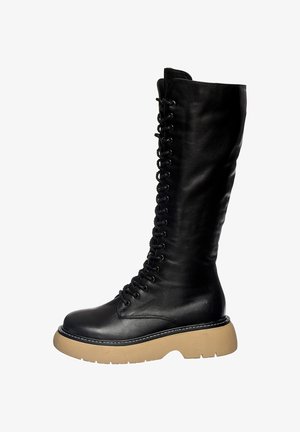 Zwarte leren kniehoge laars met een hoge, gladde schacht, vetersluiting aan de voorkant en een chunky beige platformzool. Beschikt over gestikte details.