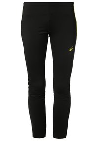 Černé přiléhavé sportovní legíny s malým žlutým logem na pravém stehně, vyrobené z hladké a elastické látky.