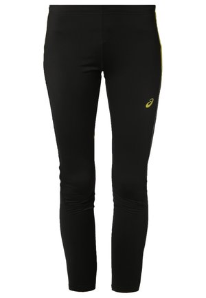 Czarny sportowy top na ramiączkach z cienkimi paskami i luźnym krojem, zestawiony z czarnymi dopasowanymi legginsami z dyskretnym logo oraz czarnymi butami do biegania.