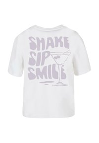 White short-sleeve t-shirt featuring purple text "SHAKE SIP SMILE" and a martini glass graphic on the back. Cotton material, relaxed fit.
