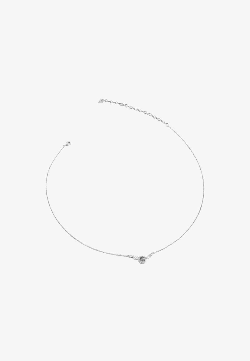 Collier délicat en argent avec un petit pendentif rond présentant un design complexe et une chaîne à fermoir réglable.