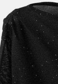 Black knit top featuring a round neckline and short sleeves, adorned with scattered silver sequins creating a textured surface.