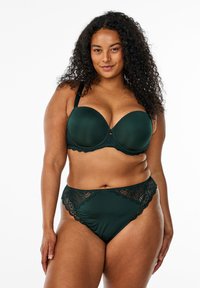 Dark green bra and matching high-waisted brief with lace accents. Bra features smooth cups and adjustable straps; brief has scalloped edges.