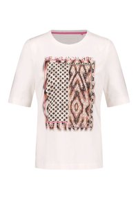White short-sleeve t-shirt featuring a mixed pattern graphic with polka dots and abstract designs, accented with a pink border and text.