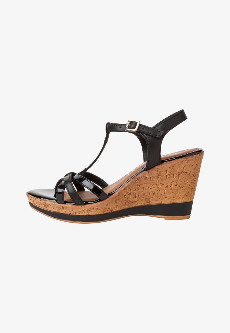 Black wedge sandal with cork heel. Features strappy design, polished sheen, and adjustable ankle strap. Thick sole for added comfort.