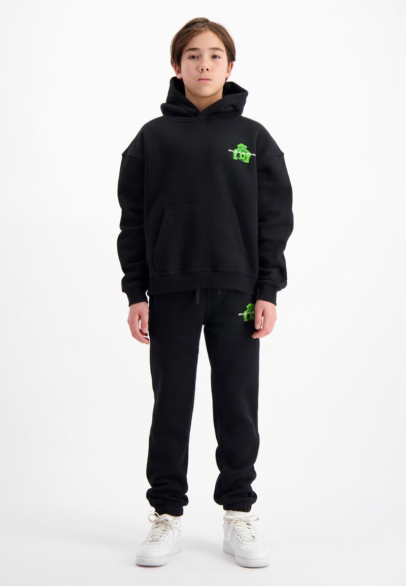 Zwart hoodie- en sweatpants-set met een voorzak, featuring groene grafische accenten. Gestructureerde stof met een relaxte pasvorm en ribgebreide boorden.