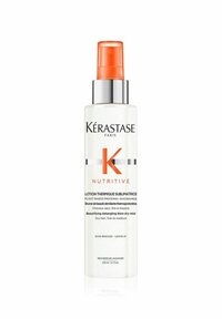 Kérastase Nutritive blow-dry mist in a transparent bottle, silver cap, and orange sprayer. Labels include product name and usage instructions.