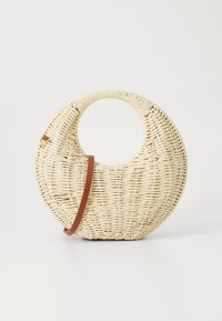 Round woven handbag in natural straw with a textured finish. Features a smooth brown leather strap and circular handle.