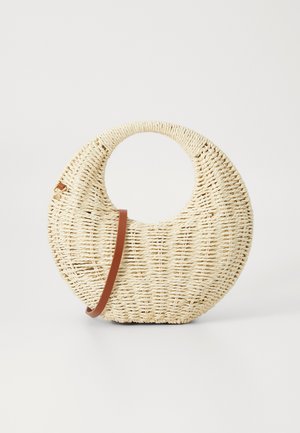 Round woven handbag in natural straw with a textured finish. Features a smooth brown leather strap and circular handle.