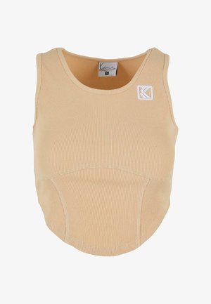 Débardeur beige à côtes avec un col rond, comportant un petit patch logo blanc et un design sans coutures sur le corps.