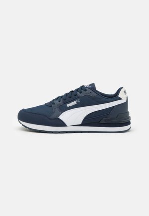 Navy blue athletic shoe with white accents, featuring a smooth synthetic upper, lace-up design, and textured grip sole.