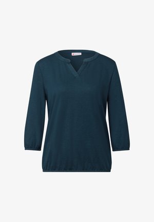 Teal, lange mouwen top met een V-hals en elastische manchetten. Gemaakt van zachte stof met een losse pasvorm en een licht uitlopende zoom.