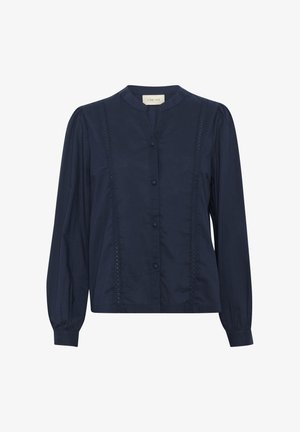 Blouse bleu marine à manches longues avec un col mandarin, fermeture à boutons sur le devant et des détails en dentelle verticale sur les côtés. Tissu au toucher lisse.