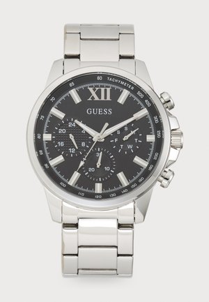 Montre analogique en acier inoxydable argenté avec un cadran noir, des index horaires blancs, trois sous-cadrans et des marquages de tachymètre sur la lunette.