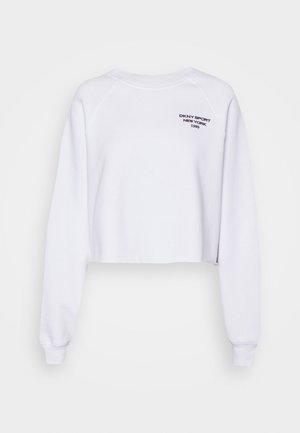 Witte cropped sweatshirt met lange mouwen, geribbelde manchetten en een ronde halslijn. Heeft een zwart "DKNY SPORT NEW YORK 1989"-logo dat aan de voorkant is gedrukt.