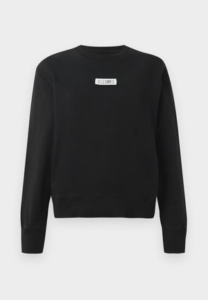 Black sweatshirt in cotton blend with ribbed crew neck and cuffs. Features a rectangular white label on the chest with black text.