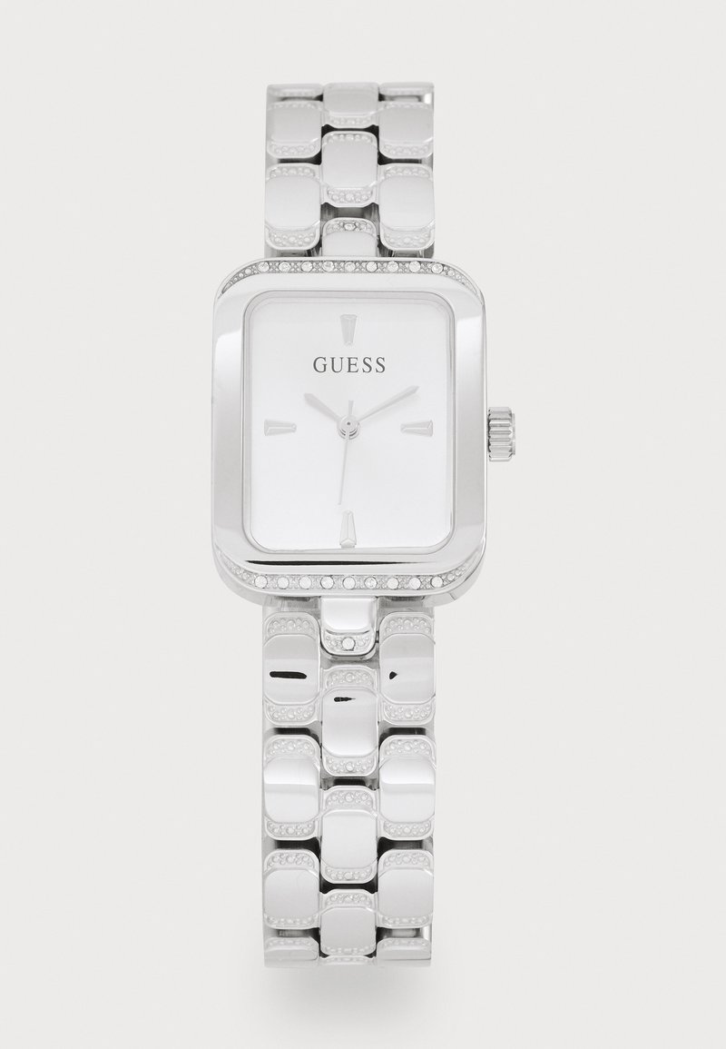 Silver rectangular watch with a polished metal bracelet and a white face. Features hour markers and a crystal-accented bezel. Brand: Guess.