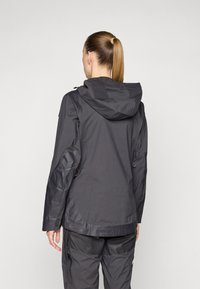 Waterproof jacket in dark gray with a hood, made of a smooth, lightweight material. Features adjustable toggles and zippered side pockets.