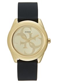 Montre dorée avec un boîtier rond, un bracelet en silicone noir et un cadran doré clair arborant un motif logo et de simples index horaires.