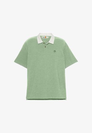 Mintgrön polotröja med vit krage, korta ärmar, tre knappar och broderad logotyp på bröstet. Mjuk och behaglig tygttextur.