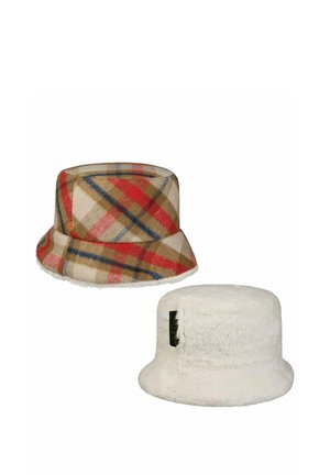 Two bucket hats: one with beige, red, blue, and brown plaid pattern; the other white and fluffy with a black label on the side.