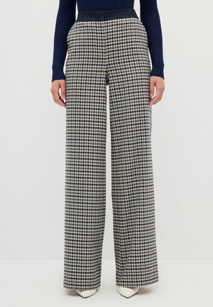 Weite Hose in einem Hahnentritt-Muster mit navy und beige Farben. Hergestellt aus gewebtem Stoff mit glatter Textur und einem taillierten Bund.