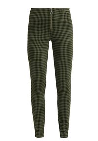 Gröna rutiga byxor med blixtlås stängning och en rund silverring. Tillverkade av texturerad tyg, figursydd design och avsmalnande ben.