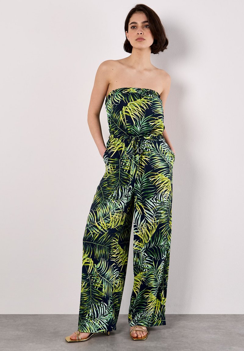 Mono sin tirantes en azul oscuro con un patrón de hojas tropicales en verde y amarillo, que presenta una cintura elástica y bolsillos laterales.