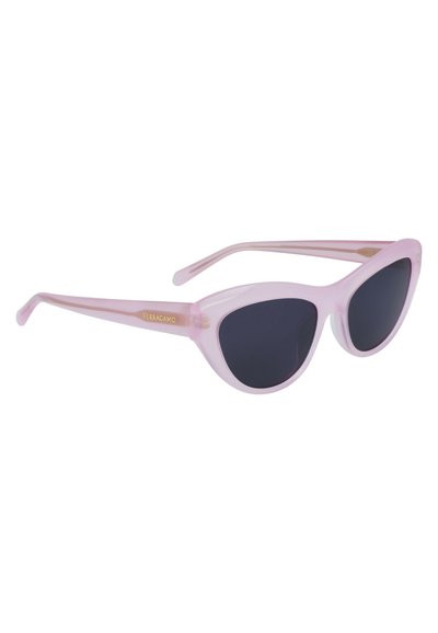 Pink translucent cat-eye sunglasses with dark lenses. Features thin arms and gold branding on the side. Smooth plastic material.