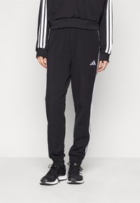 adidas Sportswear - ESSENTIALS 3-STRIPES JOGGER - Pantalon de survêtement - black/white Image miniature 1