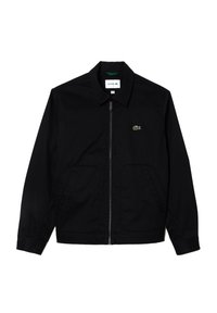 Melnā kokvilnas auduma jaka ar rāvējslēdzēju; iezīmēta ar smailu apkakli, divām priekšējām kabatām un mazu zaļu logo kreisajā krūtī.