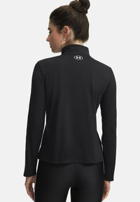 Black long-sleeve shirt made of smooth, stretchy fabric. Features a high collar and small logo on the back. Sleek design with a fitted silhouette.