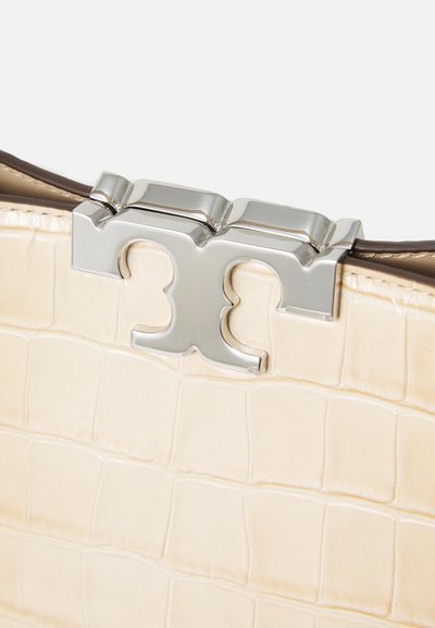 Cream textured leather handbag with crocodile pattern, featuring a shiny silver closure with a stylized logo.