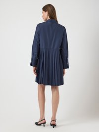 Navy blue pleated dress with a collar, long sleeves, and buttoned cuffs. The fabric appears smooth and structured, featuring a flared skirt.