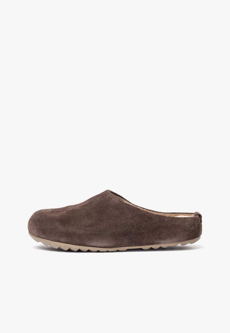 Soft brown suede slip-on slipper with tan rubber sole and fuzzy lining, designed for indoor comfort and easy wear.