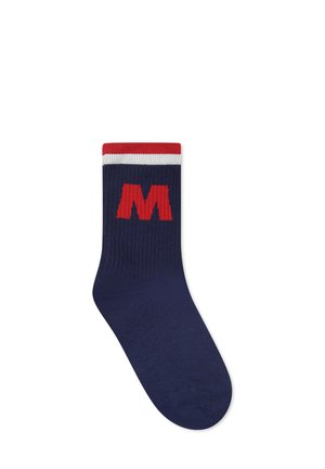 Chaussette bleu marine avec des rayures rouges et blanches en haut, arborant un grand logo rouge "M" sur le côté. Tissu tricoté avec une texture côtelée.