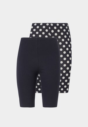 Dva páry dámskych cyklistických šortiek s vysokým pásom, jeden v jednofarebnej čiernej a druhý čierny s bielymi bodkami, zobrazené na bielom pozadí.