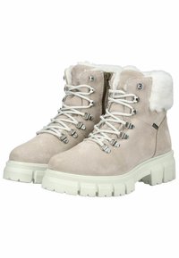 Bottines en suède beige avec garniture en fausse fourrure, lacets blancs, œillets métalliques et semelles en caoutchouc blanches et épaisses. Fermeture éclair sur le côté pour un enfilage facile.