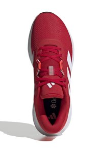 Red athletic shoe with a mesh upper, white stripes, and red laces. Features a padded collar and rubber sole for traction.