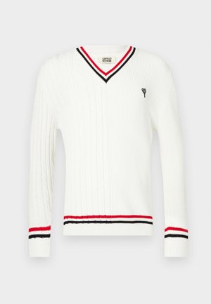 Valge soonikkoes kampsun V-kaelusega, millel on krae ja mansettide juures musta ja punast triipu ning väike tikitud muster.