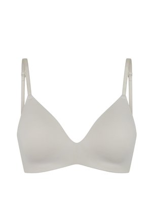 Reggiseno wireless beige chiaro senza cuciture con spalline regolabili e coppe sagomate, progettato per un supporto e un comfort ottimali.