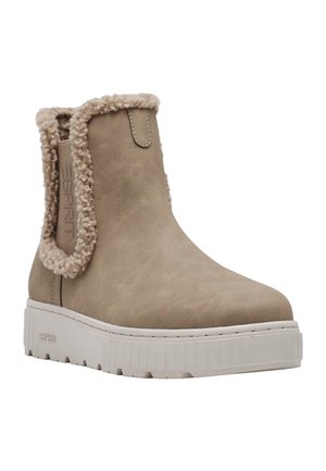 Beige ankelskodd med vit klumpig sula, fuskantad kant i fårskinn, elastisk sidpanel och Esprit-märkning på sidan och sulan.