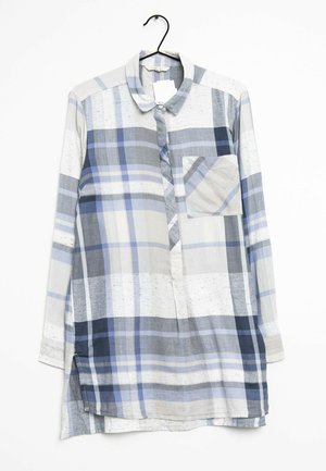 Camicia a maniche lunghe, con bottoni, in varie sfumature di plaid blu e grigio; presenta una tasca sul petto e aperture laterali. Il materiale sembra leggero.